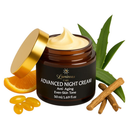 Open jar of Luminous Care Advanced Night Cream 50 ml on white background, surrounded by retinol capsules, orange slice, aloe vera leaf, and licorice root, showcasing anti-aging, moisturizing, and even-skin-tone benefits